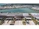 Gorgeous aerial view of waterfront neighborhood featuring boat docks, landscaping, and garages at 467 Boca Ciega Point S Blvd, St Petersburg, FL 33708