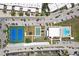 Aerial view of community amenities including tennis courts, pool, shuffleboard courts, and clubhouse with parking at 467 Boca Ciega Point S Blvd, St Petersburg, FL 33708