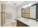 Modern bathroom featuring a sleek vanity with gold fixtures and a glass-enclosed shower at 467 Boca Ciega Point S Blvd, St Petersburg, FL 33708
