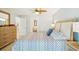 A decorative ceiling fan adds style to this bright bedroom with plank flooring at 467 Boca Ciega Point S Blvd, St Petersburg, FL 33708