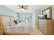 Cozy bedroom featuring a ceiling fan and a serene view from the sliding glass doors at 467 Boca Ciega Point S Blvd, St Petersburg, FL 33708