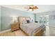 Tranquil bedroom with a ceiling fan, neutral tones, and sliding door access to outdoor area at 467 Boca Ciega Point S Blvd, St Petersburg, FL 33708