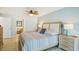 Comfortable bedroom with ceiling fan, light blue walls, and ensuite bathroom view at 467 Boca Ciega Point S Blvd, St Petersburg, FL 33708