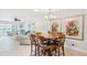 Open floor plan with dining space leading to the living room with outdoor access and waterfront view at 467 Boca Ciega Point S Blvd, St Petersburg, FL 33708