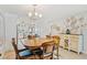 Well-lit dining area with wooden table and kitchen access for easy serving at 467 Boca Ciega Point S Blvd, St Petersburg, FL 33708