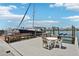 Waterfront view of boat dock with patio furniture to sit and enjoy the beautiful views at 467 Boca Ciega Point S Blvd, St Petersburg, FL 33708