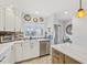 Well-lit kitchen featuring white cabinets, stainless steel appliances, and sleek countertops at 467 Boca Ciega Point S Blvd, St Petersburg, FL 33708