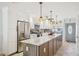 Bright kitchen featuring white cabinets, stainless appliances, and a large center island at 467 Boca Ciega Point S Blvd, St Petersburg, FL 33708