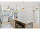 Kitchen island with barstool seating, white countertops, and pendant lights for a modern feel at 467 Boca Ciega Point S Blvd, St Petersburg, FL 33708