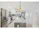 Bright kitchen with a large island, stainless appliances, and white cabinetry at 467 Boca Ciega Point S Blvd, St Petersburg, FL 33708