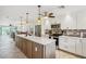 Open concept kitchen with quartz counters, island, stainless appliances, and tiled backsplash at 467 Boca Ciega Point S Blvd, St Petersburg, FL 33708