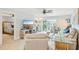 Cozy living room with waterfront views, comfortable seating, and adjacent to a bedroom at 467 Boca Ciega Point S Blvd, St Petersburg, FL 33708