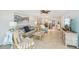 Open-concept living room with tile floors, stylish furnishings, and ample natural light at 467 Boca Ciega Point S Blvd, St Petersburg, FL 33708
