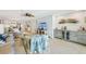 Bright living room featuring tile floors, ceiling fan, and a convenient bar area with beverage cooler at 467 Boca Ciega Point S Blvd, St Petersburg, FL 33708