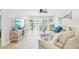 Spacious living room with tile floors, comfortable seating, and sliding doors to the outdoor patio at 467 Boca Ciega Point S Blvd, St Petersburg, FL 33708