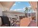 Private tiled patio featuring a dining set, barbecue grill, and views of palm trees at 467 Boca Ciega Point S Blvd, St Petersburg, FL 33708
