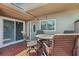 Tiled patio with a dining set and views of the home's entrance at 467 Boca Ciega Point S Blvd, St Petersburg, FL 33708