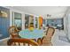 Cozy sunroom featuring nautical accents, woven chairs, and sliding glass doors at 467 Boca Ciega Point S Blvd, St Petersburg, FL 33708
