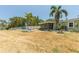 Spacious backyard featuring an in-ground pool, screened-in porch, lush foliage, and seating area at 4681 Carson Ne St, St Petersburg, FL 33703