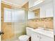 Well-lit bathroom features a glass-enclosed shower, white vanity, and decorative tile accents at 4681 Carson Ne St, St Petersburg, FL 33703