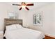 Comfortable bedroom featuring natural light from shuttered windows and a ceiling fan for climate control at 4681 Carson Ne St, St Petersburg, FL 33703