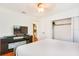 Cozy bedroom with minimalist decor, featuring a bed, a TV, and a closet for storage at 4681 Carson Ne St, St Petersburg, FL 33703