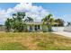 Charming single story home with a well maintained lawn, and a welcoming front porch with white chairs at 4681 Carson Ne St, St Petersburg, FL 33703