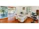 Bright living space with wood floors, a comfortable sofa, and a glimpse into a sunny sunroom at 4681 Carson Ne St, St Petersburg, FL 33703