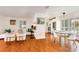 Inviting living space with wood floors, a white couch and chairs, and a stylish marble table in dining area at 4681 Carson Ne St, St Petersburg, FL 33703