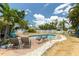Relaxing pool area with lounge chairs, tropical landscaping, and blue skies at 4681 Carson Ne St, St Petersburg, FL 33703