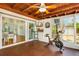 Bright sunroom with wood ceiling, exercise bike, and sliding glass doors to the main house at 4681 Carson Ne St, St Petersburg, FL 33703