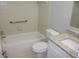 Clean bathroom featuring a white tub, toilet, and granite countertop sink at 4725 Joseph Ct # 233, Tampa, FL 33614
