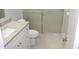 Bathroom with white vanity, granite countertop, toilet, and glass-enclosed shower at 4725 Joseph Ct # 233, Tampa, FL 33614