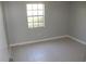 Unfurnished bedroom featuring tile flooring, neutral paint, bright window and a closet at 4725 Joseph Ct # 233, Tampa, FL 33614