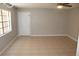 Unfurnished living room showcasing tile flooring, neutral paint, bright windows and ceiling fan at 4725 Joseph Ct # 233, Tampa, FL 33614