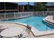 Community pool surrounded by a white fence and multiple units in the background at 4725 Joseph Ct # 233, Tampa, FL 33614