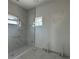 Bathroom area with white marble tile, a window, and new fixtures, still in progress at 4920 72Nd N St, St Petersburg, FL 33709