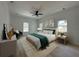 Stylishly decorated bedroom with a large bed, windows, neutral color palette, and a ceiling fan at 4920 72Nd N St, St Petersburg, FL 33709