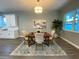Inviting dining area with stylish rug, table seating for four, modern light fixture, and ample light at 4920 72Nd N St, St Petersburg, FL 33709