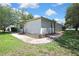 Exterior view of the backyard showing a brick path leading to the pool area at 5042 Gaston St, Spring Hill, FL 34607