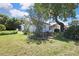 Landscaped backyard with mature trees offering shade and privacy to the property at 5042 Gaston St, Spring Hill, FL 34607