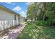 Exterior view of the backyard showing a brick path leading to the pool area at 5042 Gaston St, Spring Hill, FL 34607