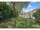View of the expansive and well-maintained backyard with view of the home's screened in pool area at 5042 Gaston St, Spring Hill, FL 34607
