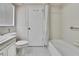 Bathroom featuring tub shower, toilet, and white tile at 5042 Gaston St, Spring Hill, FL 34607