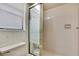 Bathroom with frosted glass shower stall, toilet, window and tile walls at 5042 Gaston St, Spring Hill, FL 34607