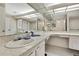Bathroom with vanity and sinks with granite countertop, large mirror, and tile floor at 5042 Gaston St, Spring Hill, FL 34607