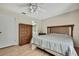 Bedroom featuring wood floor, ceiling fan, and wooden dresser at 5042 Gaston St, Spring Hill, FL 34607