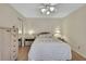 Bright bedroom with laminate floors, ceiling fan, mirrored closet doors, and a comfortable bed at 5042 Gaston St, Spring Hill, FL 34607