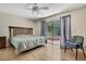Bedroom featuring hardwood floor, ceiling fan, bed and sliding glass doors leading to the pool at 5042 Gaston St, Spring Hill, FL 34607