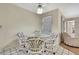 Bright dining area features a glass table with four chairs and a decorative ceiling fan at 5042 Gaston St, Spring Hill, FL 34607